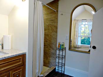 granite vanity, large tiled shower, tall mirror