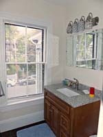 granite bathroom vanity with window and mirror