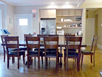 large table with tall wood chairs, kitchenette